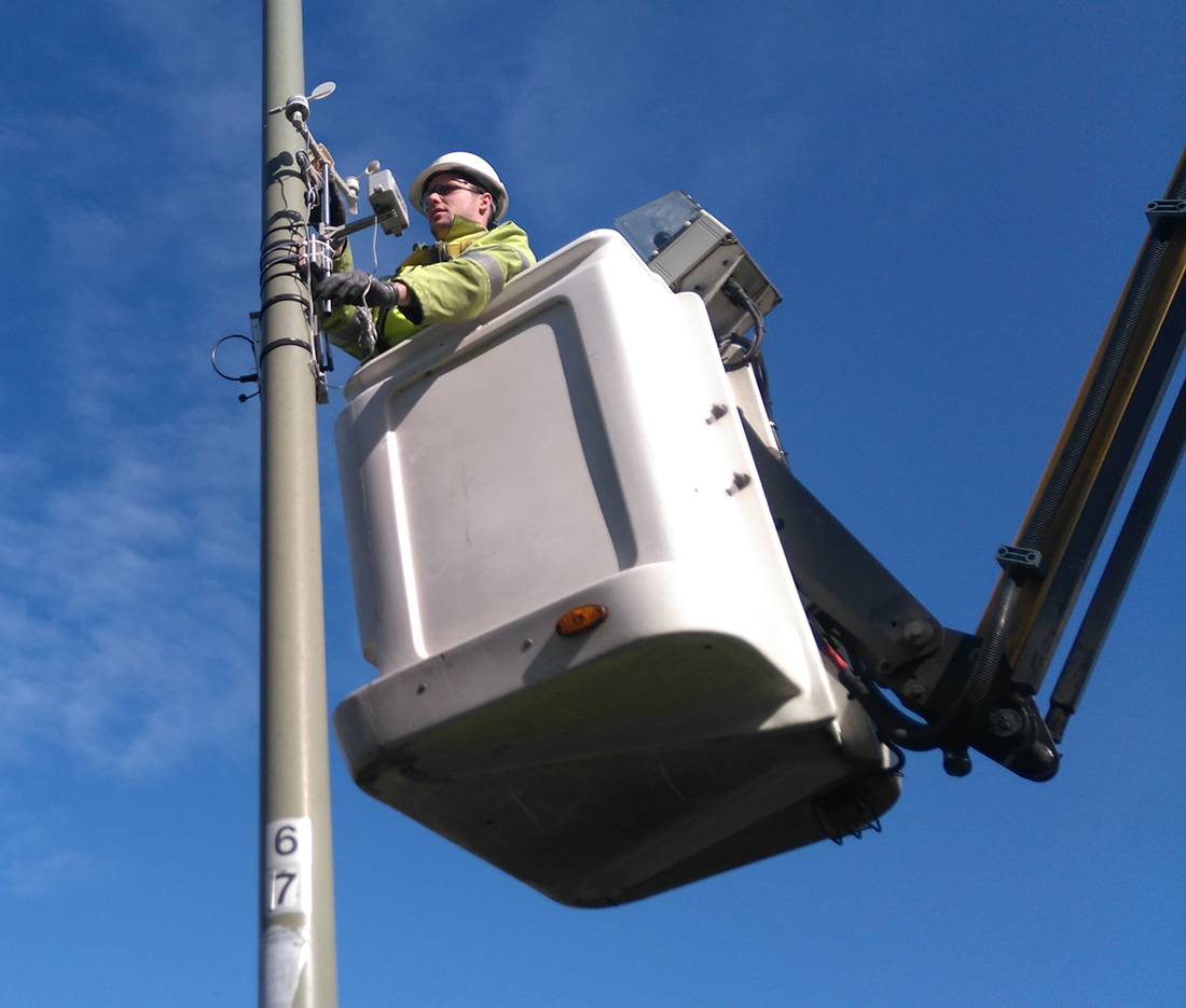 A technician installing the Weather Station A technician installing the Weather Station